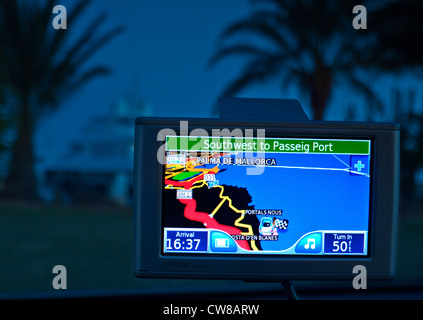 GPS satellite navigation screen in rental car at dusk showing position of car in Puerto Portals Palma de Mallorca Spain Stock Photo