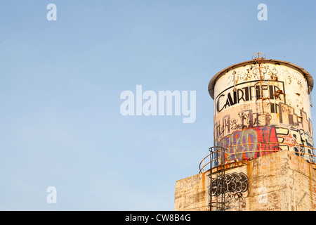 Exterior of an abandoned car factory in Detroit Michigan. There is graffiti on the tower outside of the plant. Stock Photo