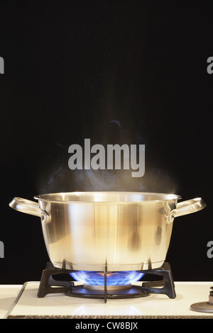 Lit Gas Stove With Pot Stock Photo