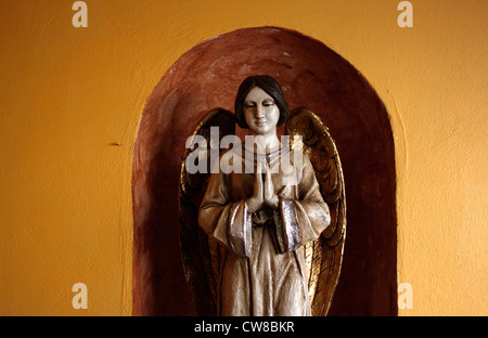 An angel with golden wings praying is displayed in Casa de los Frailes hotel in Oaxaca, Mexico, July 7, 2012. Stock Photo