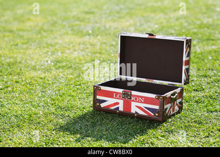 British Flag Briefcase On Grassy Field Stock Photo