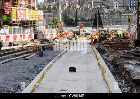 Workers constructing tram tracks in Edinburgh's Princes Street and St. Andrews Street Stock Photo