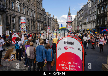 Crowds on the Royal Mile during the Edinburgh Festival with acts from the Fringe performing for free