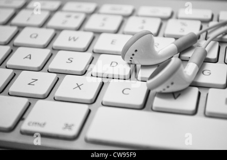 Close up of apple wireless keyboard and apple headphones Stock Photo