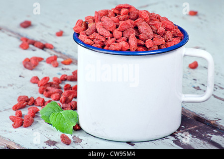 Red goji berries on a light blue rustic wooden background Stock Photo