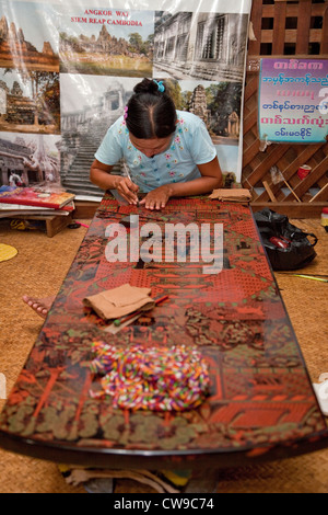 Myanmar, Burma. Bagan. Lacquerware Workshop, Woman at Work Refining Design on Lacquered Coffee-Table Top. Stock Photo