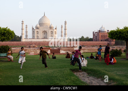 Families having fun in the Moonlight Garden, Mahtab Bagh, with the Taj Mahal in the background Stock Photo