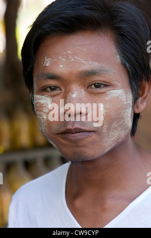 Myanmar, Burma. Young Burmese Man with Thanaka Paste on Face as a Cosmetic Sunscreen. Stock Photo