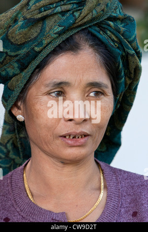 Head and shoulders portrait of a Burmese woman with face covered in ...