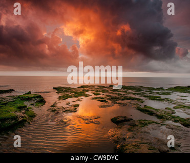 Early morning sunrise in Walton On The Naze ,Essex, a storm brewing and just an explosion set the clouds alight. Stock Photo