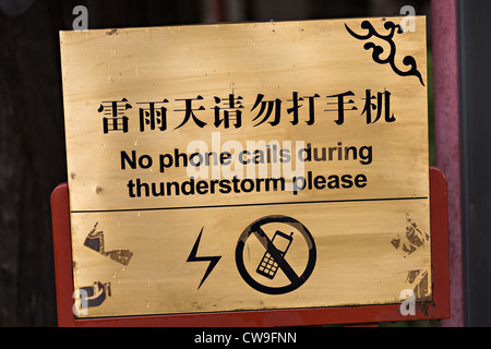 Sign warning not to use mobile phones during thunderstorms in Beijing, China Stock Photo
