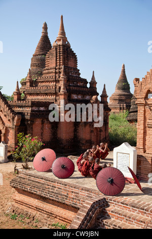 Myanmar, Burma. Bagan. Young Novice Monks Praying Outside a Temple. Stock Photo