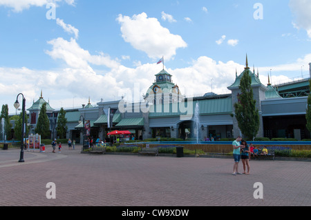 Two tourists looking at a map at La Ronde Six Flags amusement park near the gate Montreal Canada Stock Photo