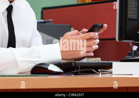 Businessman play smart phone during working Stock Photo
