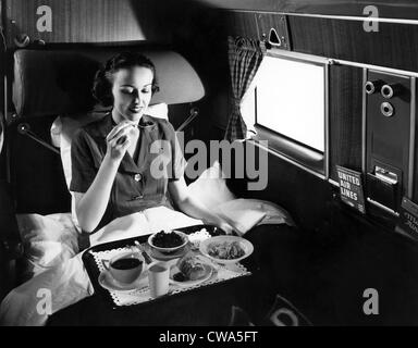 A passenger eats breakfast on United Airline's Douglas Mainliner Sleeper airplane from Chicago to San Francisco, 1937. Stock Photo