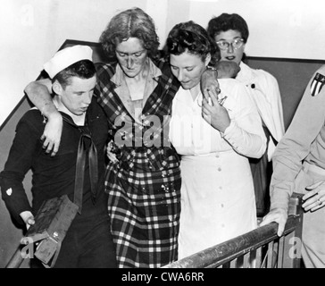 HERO OF EMPIRE STATE BUILDING DISASTER  NEW YORK--First aid kit in one hand, Don Molony, 17-year-old Coast Guardsman, helps an Stock Photo