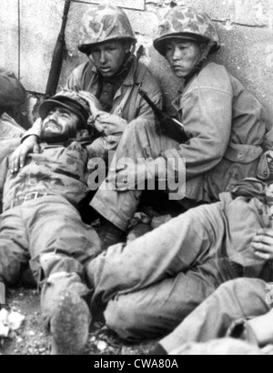 10/01/50--SOUTH KOREA: During heavy fighting, U.S. Marines snatch a moment's rest behind a wall in the streets of Seoul.. Stock Photo