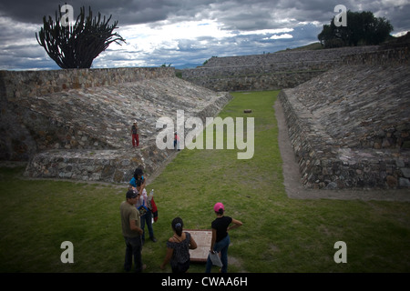 A Mexican family visits the Ball court of the Zapotec ruins of Yagul in Oaxaca, Mexico, July 7, 2012. Stock Photo