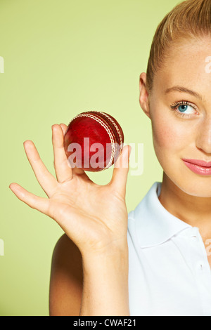Young woman holding cricket ball Stock Photo