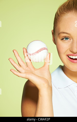 Young woman holding baseball Stock Photo