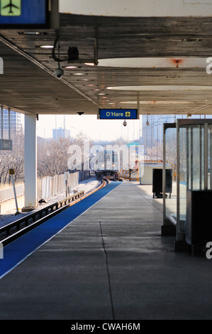 CTA rapid transit train headed for Chicago's O'Hare International Airport terminal a the platform Rosemont/River Road. Chicago, Illinois, USA.rriving Stock Photo