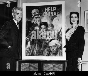 American artist and cartoonist James Montgomery Flagg and actress Loretta Young, beside the poster he created for the United Stock Photo