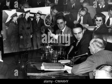 Roy Cohn (center), Senator Joseph McCarthy's attorney during the Army-McCarthy hearings, tries to prove a photo introduced by Stock Photo