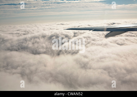 Aeroplane wing and clouds Stock Photo
