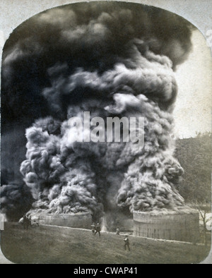 The Pennsylvania oil region. Black smoke spewing from the tops of two oil storage tanks shortly after they burst into flame at Stock Photo