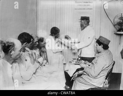 New York City's Municipal Lodging House vaccinated homeless tenants. On the wall is a poster stating the rules of the shelter. Stock Photo