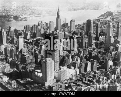 Aerial view of mid-town Manhattan during construction of Rockefeller Center.  In center background is the Chrysler building. Stock Photo