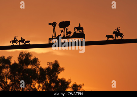 Wrought iron signs at ranch gate at sunrise near San Angelo, Tom Green County, Panhandle Plains region, Texas, USA Stock Photo