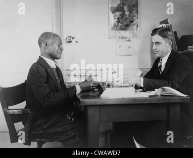 An African American farmer repays his Farm Security Administration (FSA) loan. The New Deal agency provided guidance and loans Stock Photo