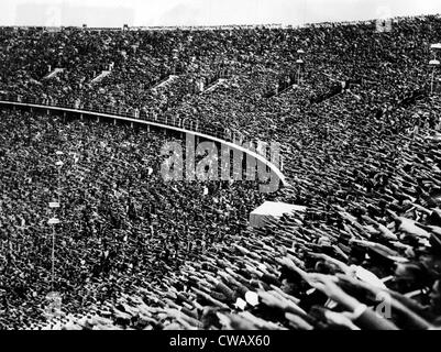 Germans giving the Nazi Salute in acknowledgement of the arrival of Adolf Hitler, at the opening of the 1936 Olympic games. Stock Photo