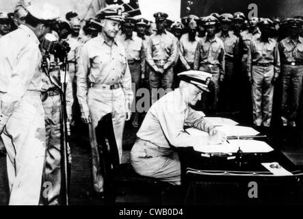 World War II, Admiral Nimitz signing Japanese surrender document aboard the U.S.S. Missouri, September 2, 1945. Stock Photo