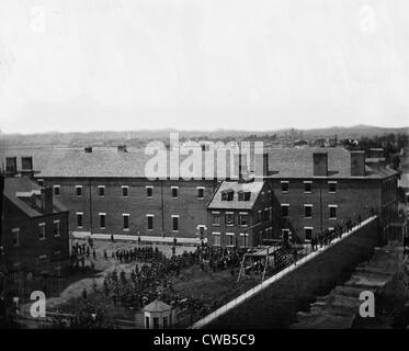 The assassination of President Abraham Lincoln, execution of the conspirators, scaffold in use and crowd in the yard, seen from Stock Photo