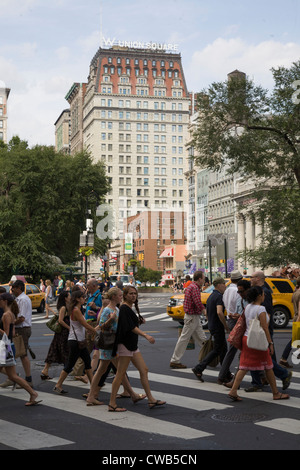 People cross the street at Broadway & Union Square along 14th St. in NYC. Stock Photo