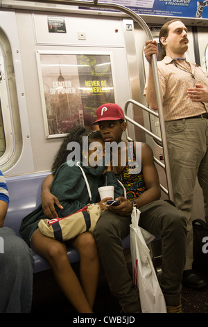 Teenage couple rides the NYC subway in New York City. Stock Photo