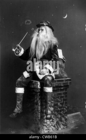 Christmas, 'caught in the act', Santa Claus seated on model of chimney smoking long pipe and blowing circles of smoke, Stock Photo