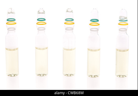 Five ampules with liquid medicine on white background Stock Photo