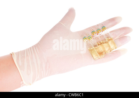 Hand in latex glove with ampules on white background Stock Photo