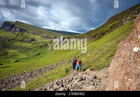 Hikers walking near the Quiraing on the Isle of Skye, Scotland, UK Stock Photo