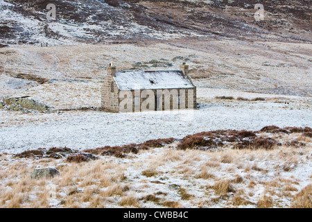 Cottage in the Scottish Highlands covered in snow Stock Photo
