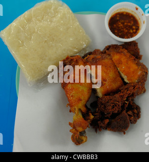 deep fried chicken and sticky rice with chilli sauce in a pot , thai street food ,bangkok, thailand Stock Photo