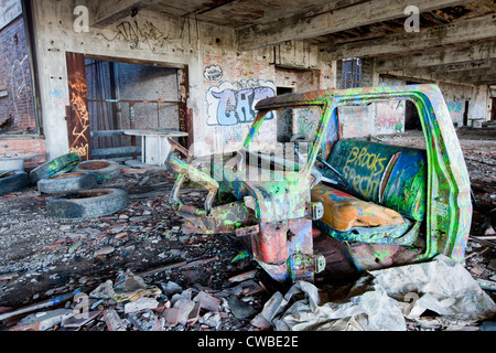 Abandoned factory in Detroit Michigan someone had taken an old cart in and covered it in graffiti. Stock Photo