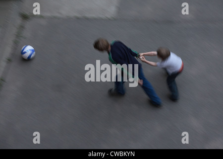 Little boy draws the bigger play in football Stock Photo