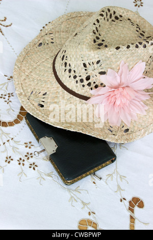 A locked diary pictured with a Lady's straw hat Stock Photo