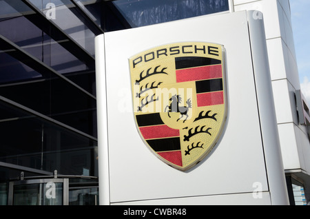 A Porsche badge outside a car showroom, London, UK Stock Photo