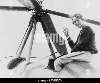 Amelia Earhart (1897-1937), waving, seated outside cockpit on top of an Autogiro, in Los Angeles, shortly after she became the Stock Photo