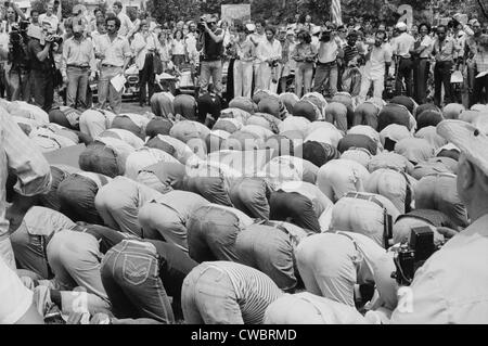 Iranian men bow in prayer during demonstration for Khomeini in Washington, D.C. during the 1979 Hostage Crisis. August 7, 1980. Stock Photo